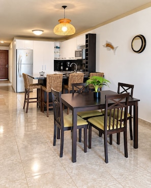 A modern kitchen with white cabinets, a built-in microwave, and a coffee machine. - Bello Apt en Playa El Angel, Pisicna +Vista al Mar (Pampatar)