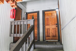 A wooden staircase leading to two doors, each marked with a number. - 2 Baths, Fireplace, Coffee Bar, Pets Welcome (McCall)