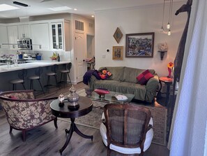 A modern living room with a sofa, two armchairs, a coffee table, and a dining area with bar stools. - Serene Sonoma Wine Country Escape – Just 7 Mins to Historic Plaza! (Sonoma)