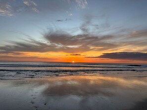 A beach with a sunset and calm waves. - Serene, Contemporary Retreat with Plunge Pool (Playa Avellanas)
