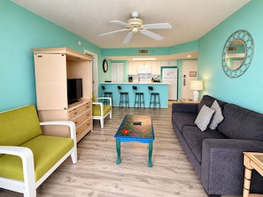 A compact living space with a kitchenette, a dining area, a sofa, and a television. - The Curaçao | Key West Condo with Pool, Balcony, & Sunset Views (Key West)