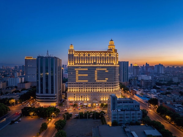 A large, multi-story building with a prominent central dome and a symmetrical facade.