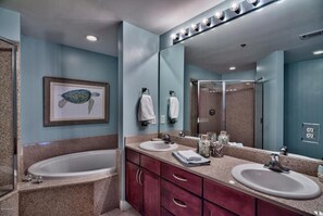 A bathroom with two sinks, a large mirror, a framed turtle picture, and a shower area. - Laketown Perch 1927-Lake Views-Sleeps 8 (Panama City)
