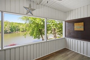 A room with a large window overlooking a lake, a star decoration, and a welcome sign. - N Lake Dr on Whitewater Lake (Salem)