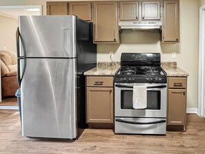 A kitchen with stainless steel appliances, including a refrigerator and a stove. - 2BR Mercer Trailside Retreat near Turtle Flambeau with WiFi, kitchen & deck (Mercer)