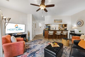 A living room with a TV, a bar area, and a dining space. - Pet-Friendly Villa Near Van Der Meer Tennis & ½ Mile to South Forest Beach (Hilton Head Island)
