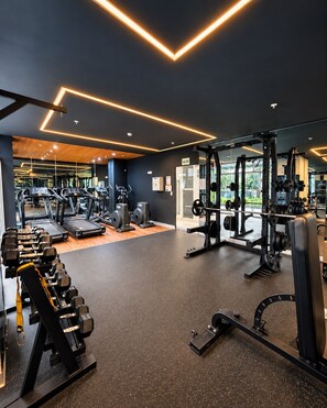 A gym with treadmills, weight machines, and free weights. - Stylish Ocean View 2BR • King Bed• Pool & Gym (Barranco)