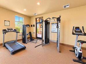 A fitness center with cardio machines, weight training equipment, and a wall-mounted pull-up bar. - Terra Summit w/ Rooftop Hot Tub + Lazy River (Hurricane)