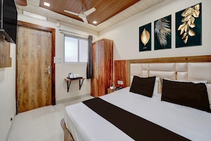 A hotel room with a bed, a wooden wardrobe, a nightstand with a phone, and a window with curtains. - Collection O Mahakal Lok Temple Ujjain (Ujjain)
