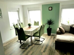 A dining area with a table, chairs, and a potted plant. - Holiday Apartment in Lubbenau With Barbecue (Lübbenau/Spreewald)