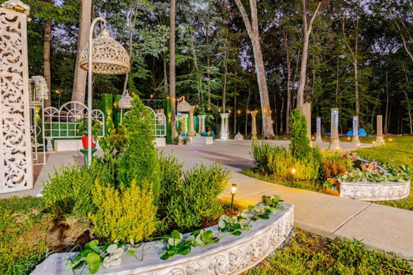 A landscaped garden with pathways, decorative lanterns, and a well-maintained lawn.