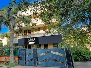 A building with a sign that reads 'Collection' and a gated entrance. - Collection O Sushant Lok Phase 1 (Gurugram)