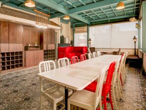 A conference room with a long table, chairs, and a red sofa. - Collection O Sushant Lok Phase 1 (Gurugram)