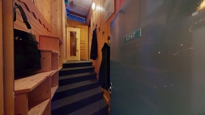 A wooden interior hallway with a staircase leading to a door marked with the number 1247. - Luxury apartment at the base of the slopes, 4 bedrooms, terraces with views of Mont Blanc, Arcs 1800 (Bourg-Saint-Maurice)