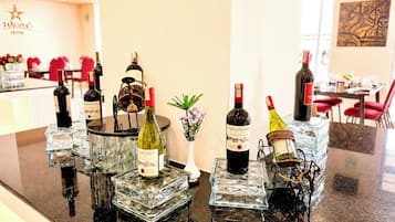 A hotel bar with multiple wine bottles displayed on glass pedestals.