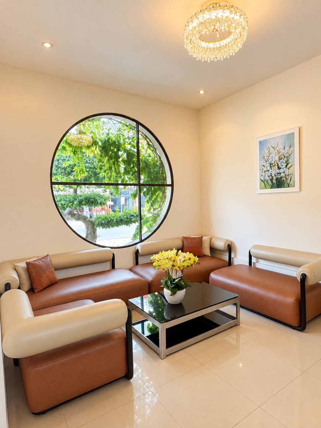 A modern living room with a sectional sofa, a glass coffee table, and a large window with a view of greenery.