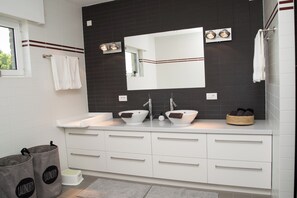 A modern bathroom with two sinks, a large mirror, and a towel rack. - Casa Tibella Holiday Home with Pool, Sauna & Jacuzzi (Ichtegem)