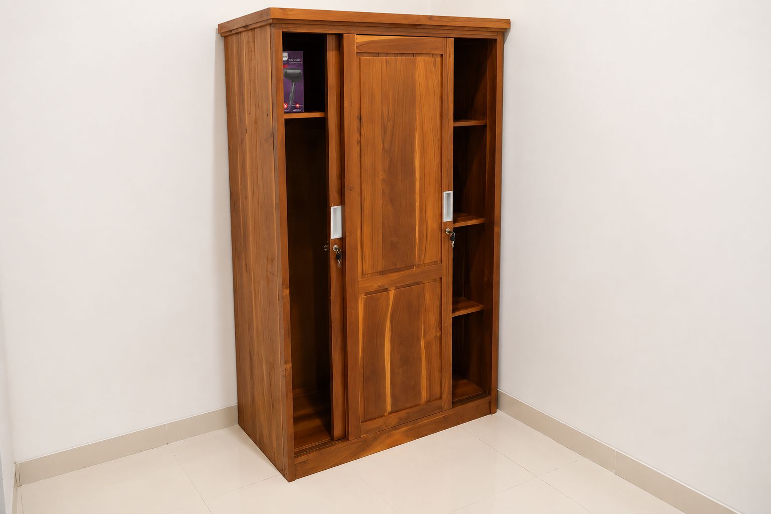 A wooden wardrobe with multiple shelves and a door, located in a corner of a room with white walls and a tiled floor.