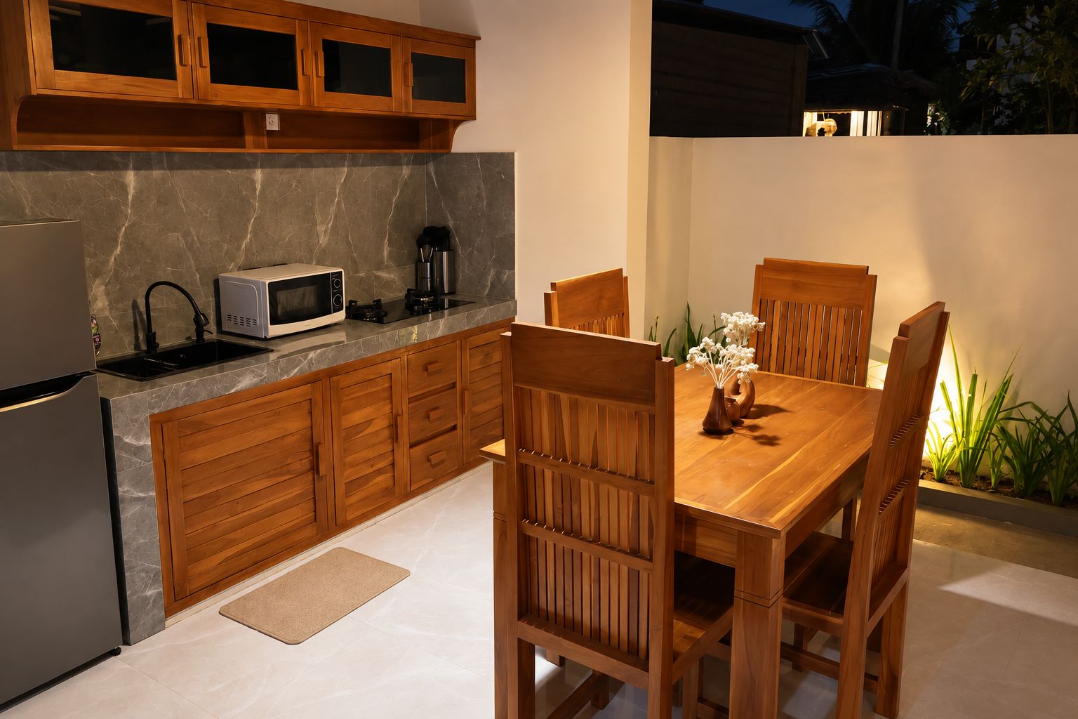 A modern kitchen with wooden cabinets, a microwave, and a dining table with chairs.