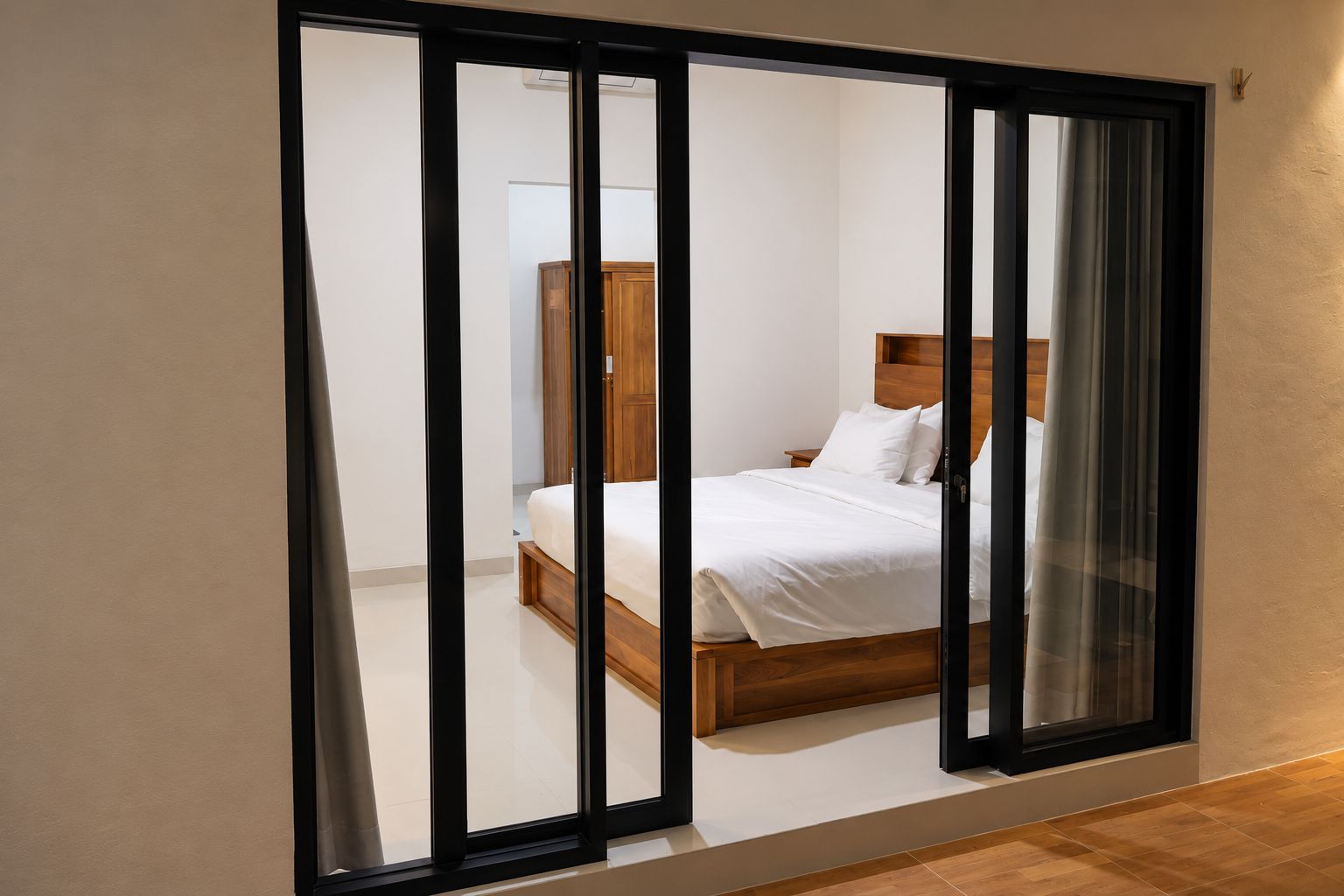 A bedroom with a bed, wooden headboard, and a nightstand.