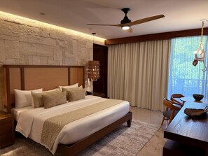 A modern hotel room with a large bed, a wooden headboard, a ceiling fan, and a view of the outdoors through the window. - Hotel Gafsacomm Palenque (Palenque)