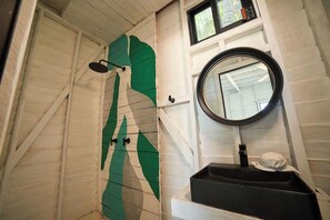 A bathroom with a shower, a sink, and a mirror. - El Faro by OOL Hotels (Isla Holbox)