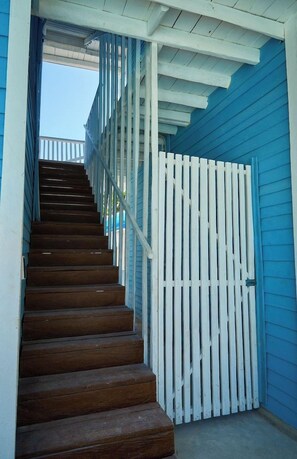 A wooden staircase with white railings leading to a door. - El Faro by OOL Hotels (Isla Holbox)