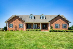 A two-story brick house with a front porch, a covered entryway, and a well-maintained lawn. - Blue Ridge Views - Near Mt Airy & Wine Trail (Ararat)