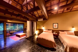A hotel room with a large bed, a small table, a bench, and a view of the outdoors. - SATONOYU WARAKU (Minamioguni)