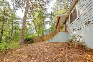 A wooden staircase leading to a house with a white exterior, surrounded by a dense forest. - Walkable Hot Springs Home! Near Nat'l Park & Dtwn (Hot Springs)