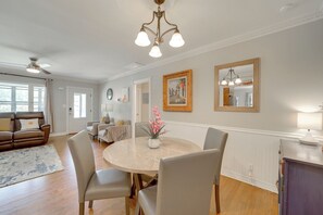 A dining area with a round table, chairs, a vase with flowers, and a ceiling fan. - Walk to Expo Square: 4 Mi to Dtwn Tulsa (Tulsa)