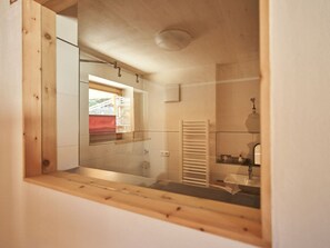 A bathroom with a glass shower enclosure, a towel rack, and a mirror. - Holiday Apartment With 1 Bedroom (Bad Toelz)