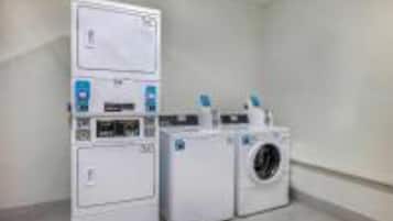 A laundry room with stacked washer and dryer units.