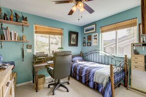 A bedroom with a bed, desk, chair, and a ceiling fan. - Creekside New Castle Townhome w/ Scenic Deck (New Castle)
