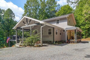 A two-story house with a covered porch and a flag. - 3 Mi to Dtwn Blue Ridge! Family Home w/ Fire Pit (Blue Ridge)