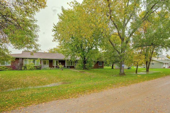 A residential area with houses, lawns, and a road.