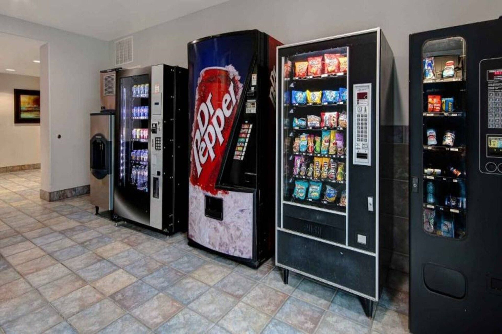 A row of vending machines with various snacks and drinks.