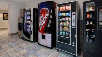A row of vending machines with various snacks and drinks, including a prominent Pepsi machine.
