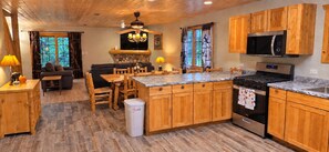 A kitchen with wooden cabinets, a built-in microwave, and a stove.