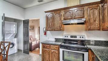 A kitchen with wooden cabinets, a built-in oven, and a microwave.