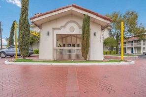 A small building with a flat roof, a balcony, and a circular window. - 2 Full Beds | Smoking (Dallas)