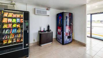 A vending machine area with a snack vending machine and a Dr Pepper vending machine.