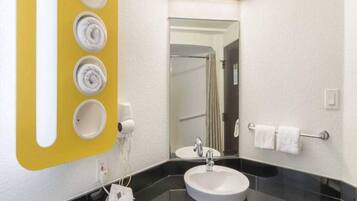 A bathroom with a black sink, a mirror, and a towel rack.