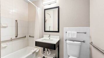 A modern bathroom with a bathtub, a sink, a toilet, and a shower.
