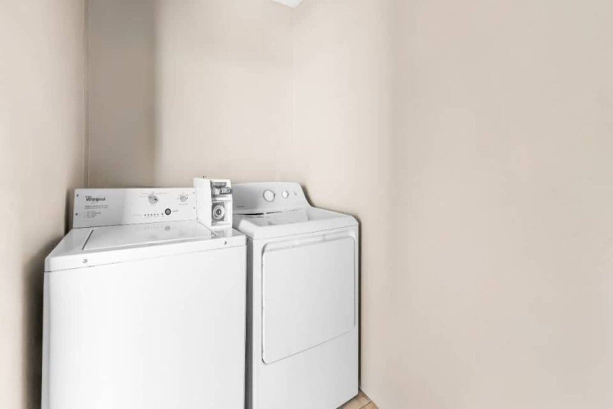 A laundry area with a front-loading washer and dryer.