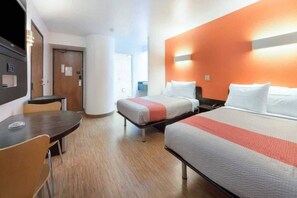 A hotel room with two beds, a desk, and a chair. - 2 Full Beds | Non-Smoking (Dallas)