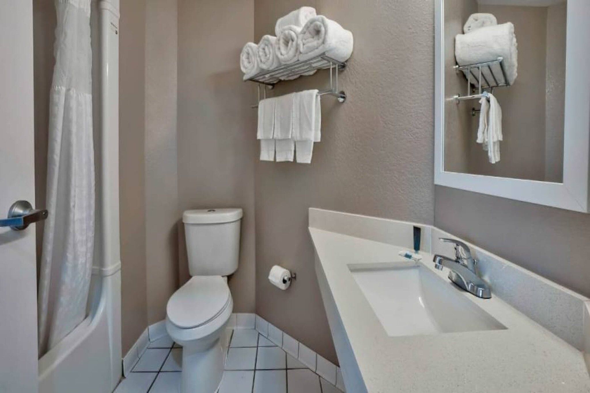 A bathroom with a toilet, a sink, and a shower curtain.