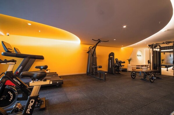 A gym with exercise equipment including a stationary bike, a treadmill, and weight machines. - Beautiful view (Quito)