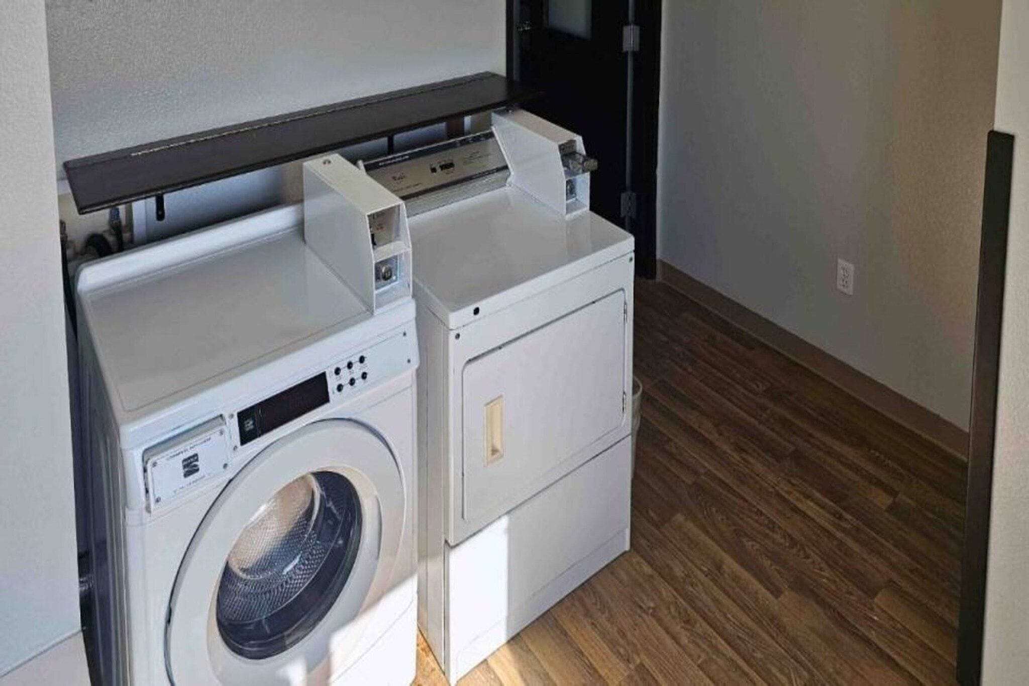 A compact laundry area with a washing machine and a dryer.