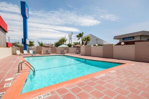 A swimming pool with a no diving sign, surrounded by lounge chairs and umbrellas, with a clear sky above. - Sunny 2 FULL BEDS | SMOKING (El Paso)